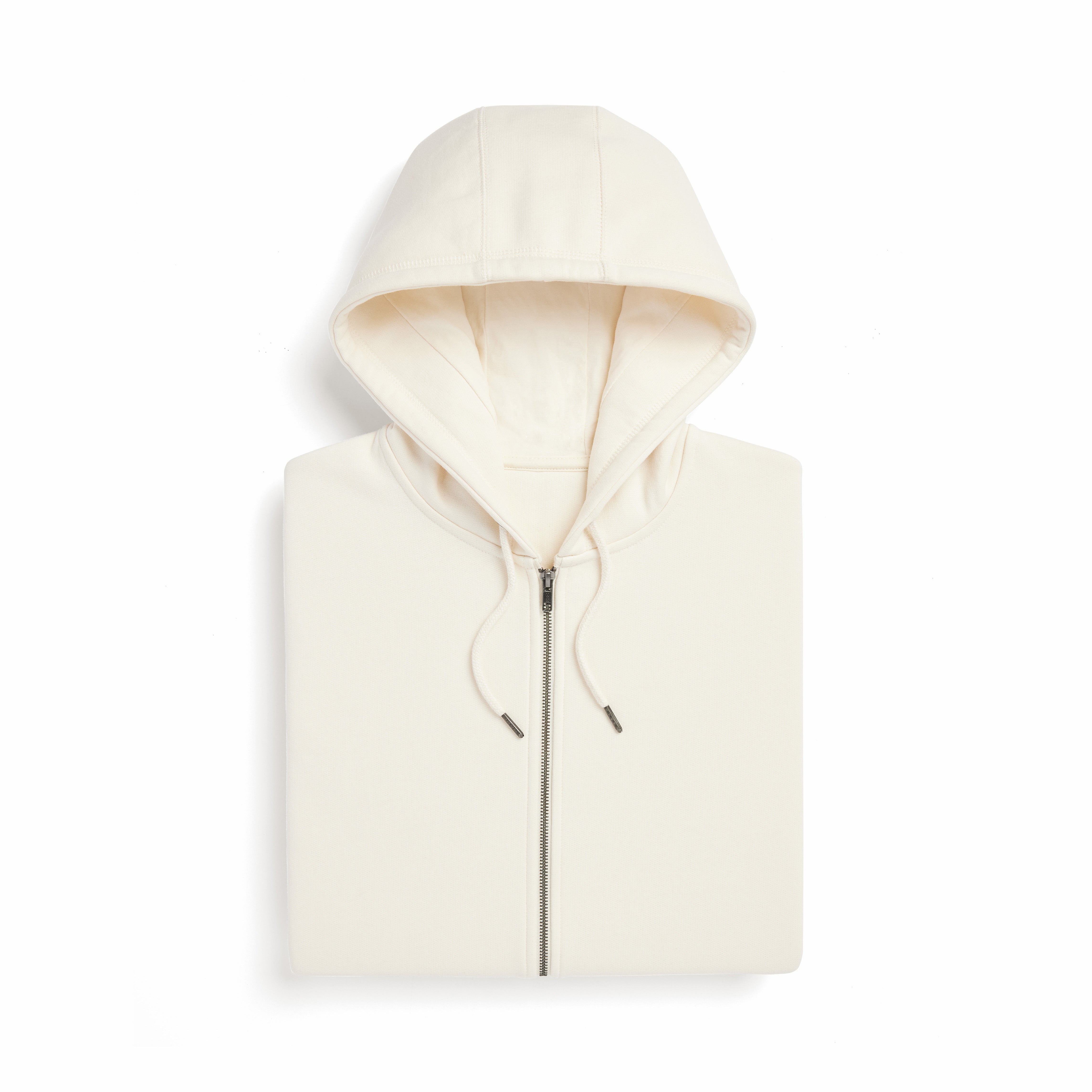 a neatly folded cream colored hoodie displaying the hood, zipper, and drawstrings.