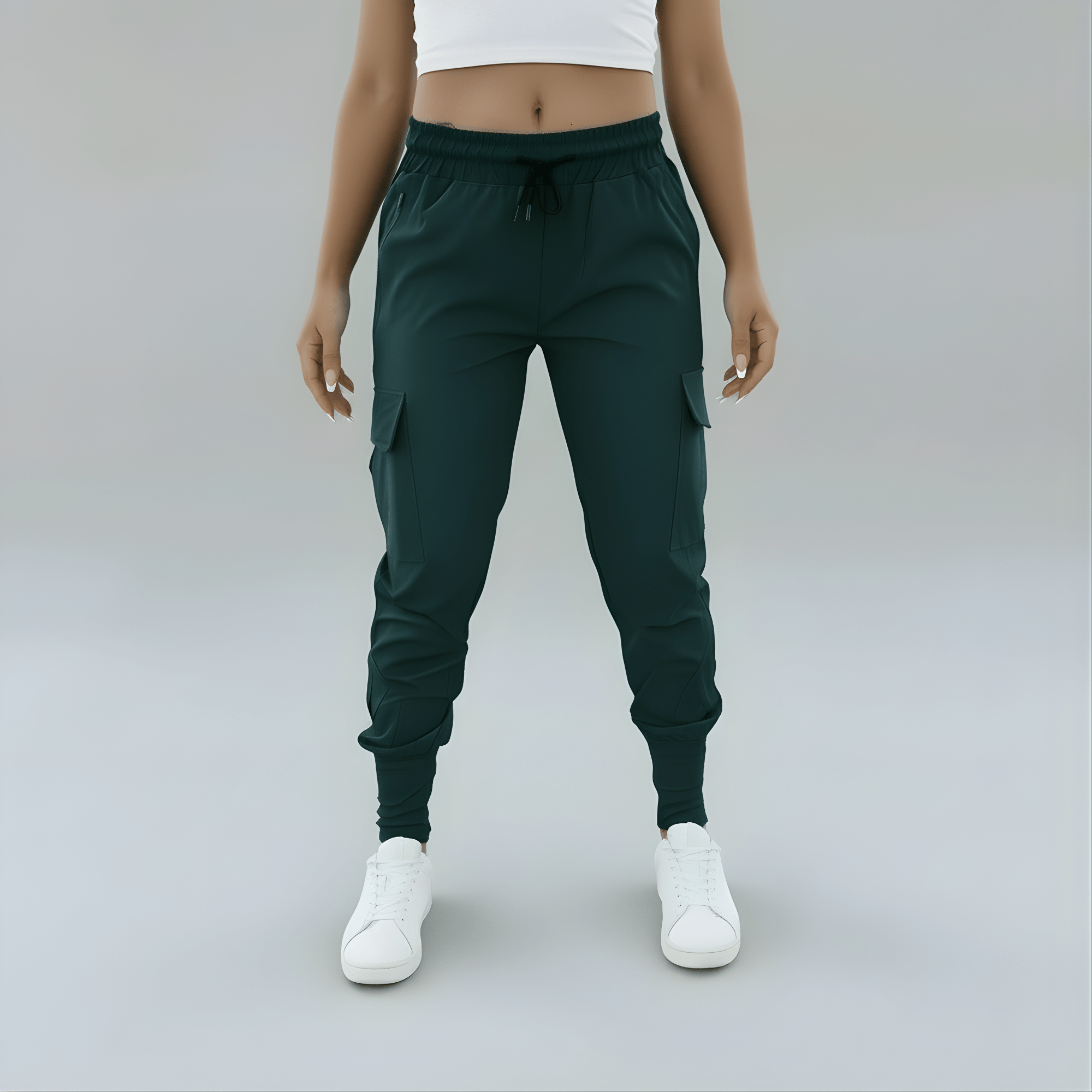 Person wearing dark green jogger pants and white sneakers on a plain background