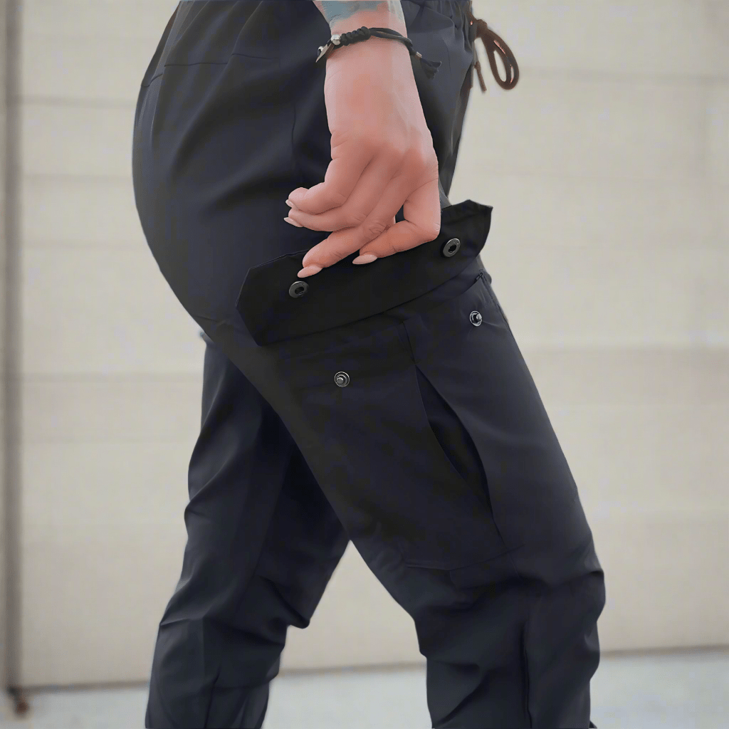 Person wearing black pants with a neutral background