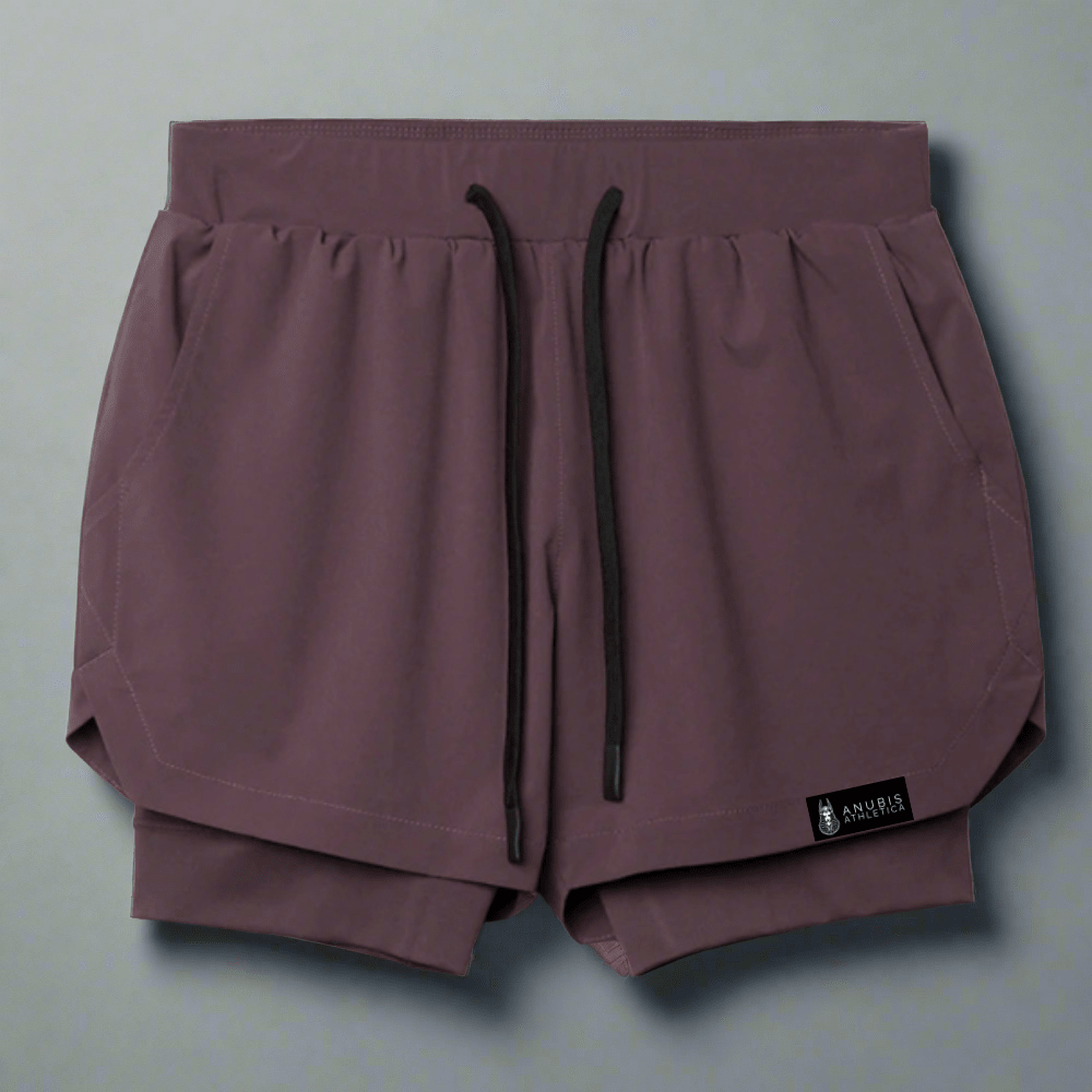 Pair of maroon shorts with a drawstring on a light gray background