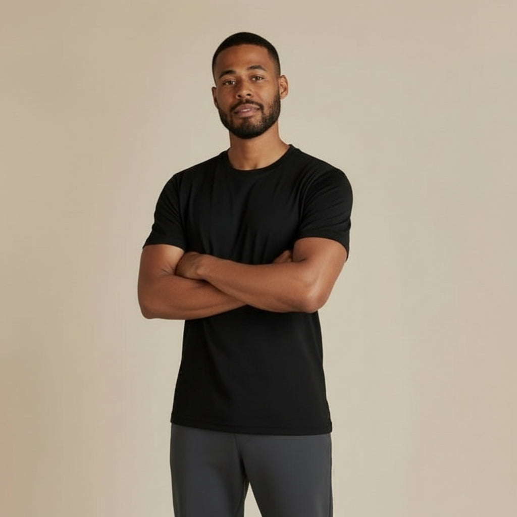 Man wearing a black t-shirt against a beige background