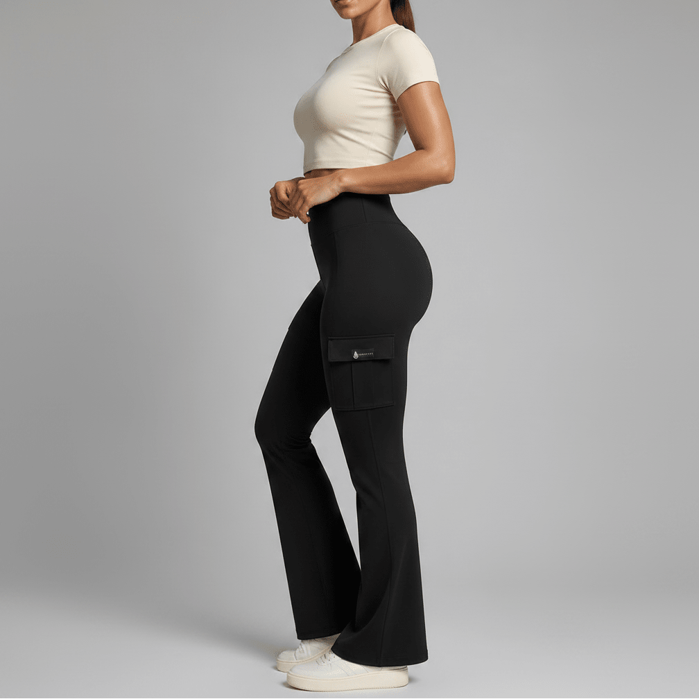 Person wearing black cargo pants and a beige top on a gray background