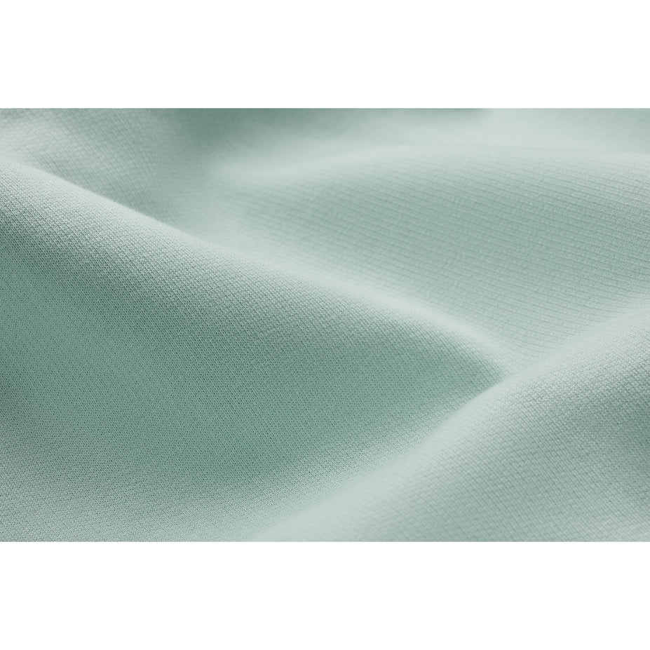 a close up view of the fabric of a seafoam hoodie showing the softness