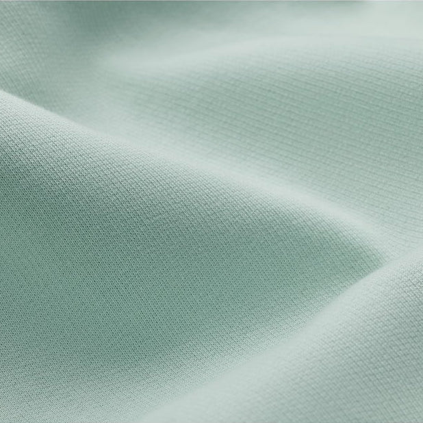 a close up view of the fabric of a seafoam hoodie showing the softness