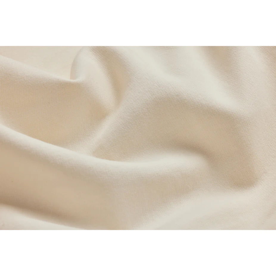 close up view of a cream colored hoodie to show the fabric softness