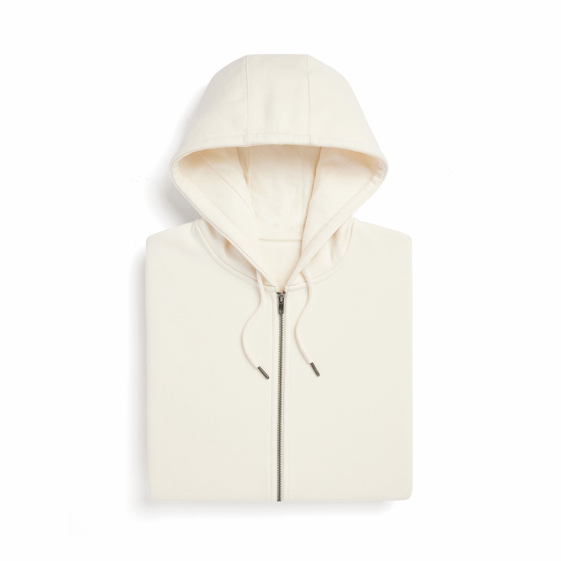 a neatly folded cream colored hoodie displaying the hood, zipper, and drawstrings. 