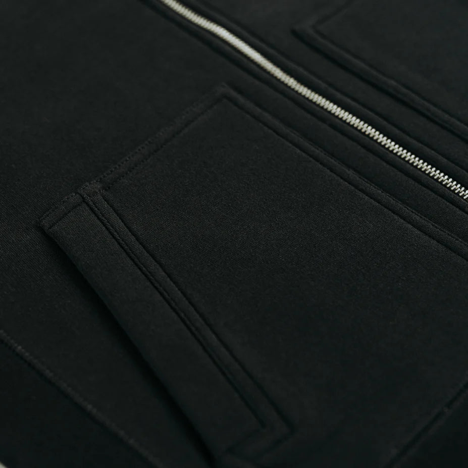 a close up view of the zipper and one of the pockets of the black hoodie