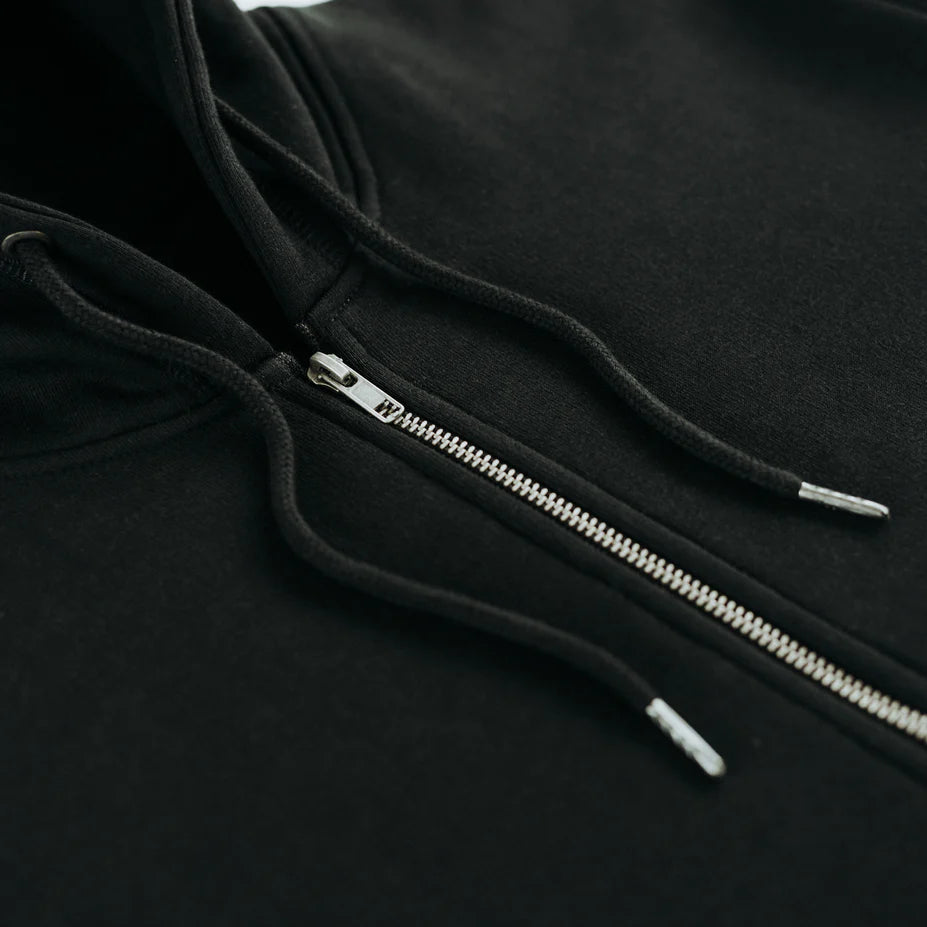 a close up view of the zipper and drawstrings of a black hoodie