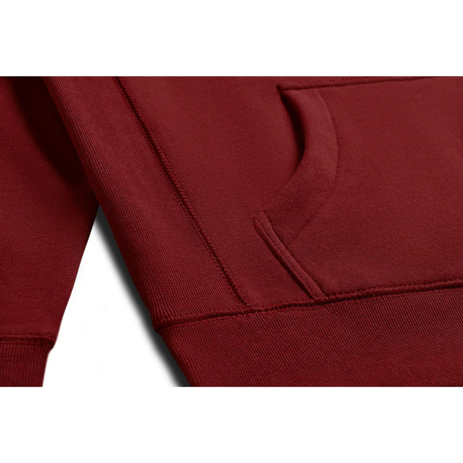 a close up view of the pocket of an oxblood red hoodie