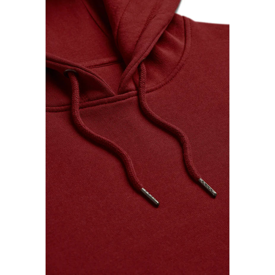 a close up view of the drawstrings of an oxblood red hoodie