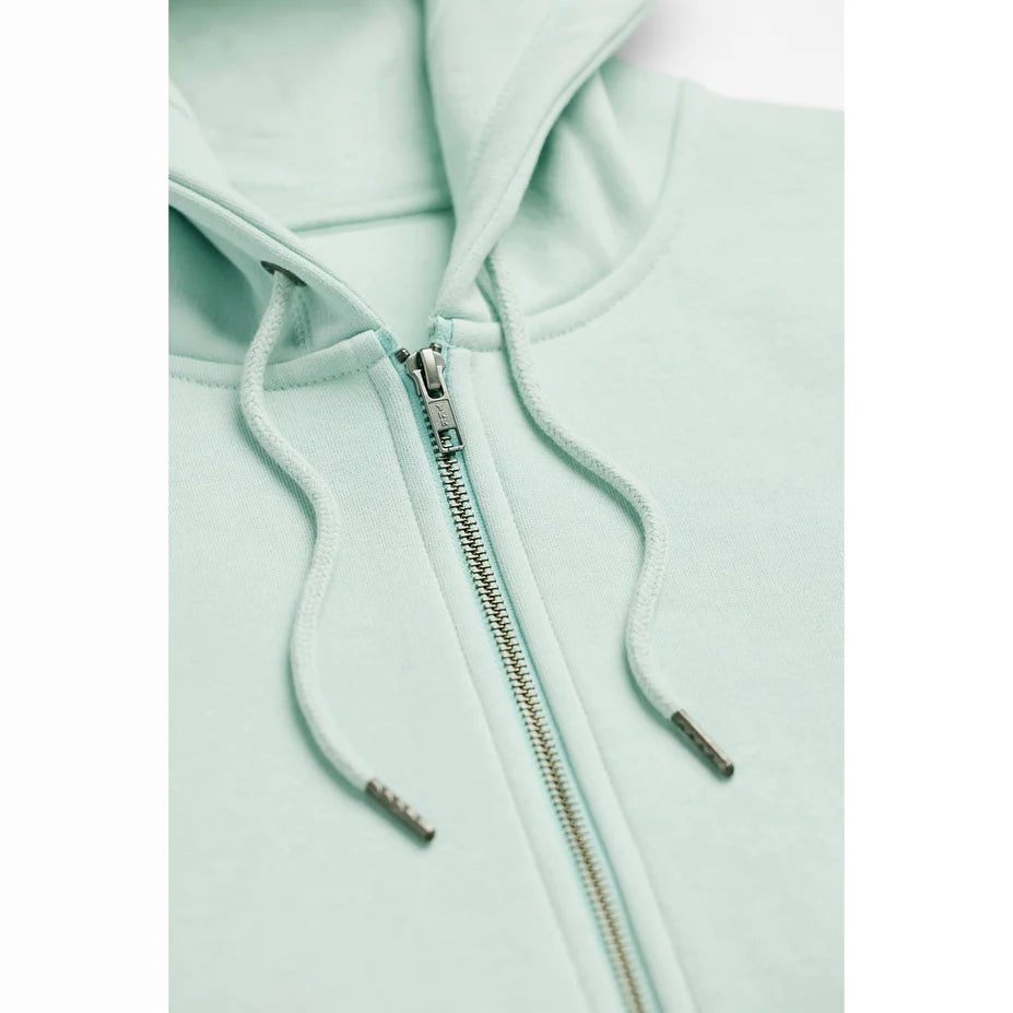 a close up view of a seafoam colored zip up hoodie showing the zipper and drawstrings