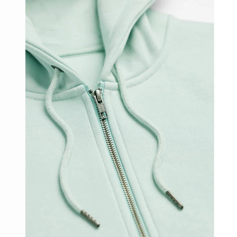 a close up view of a seafoam colored zip up hoodie showing the zipper and drawstrings