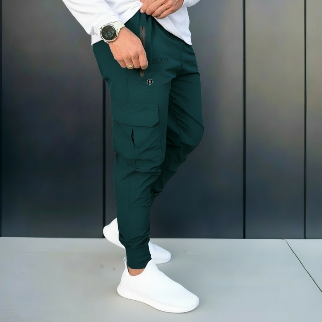 Person wearing green pants and white shoes against a dark background