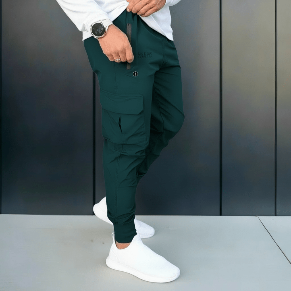 Person wearing green pants and white shoes against a dark background