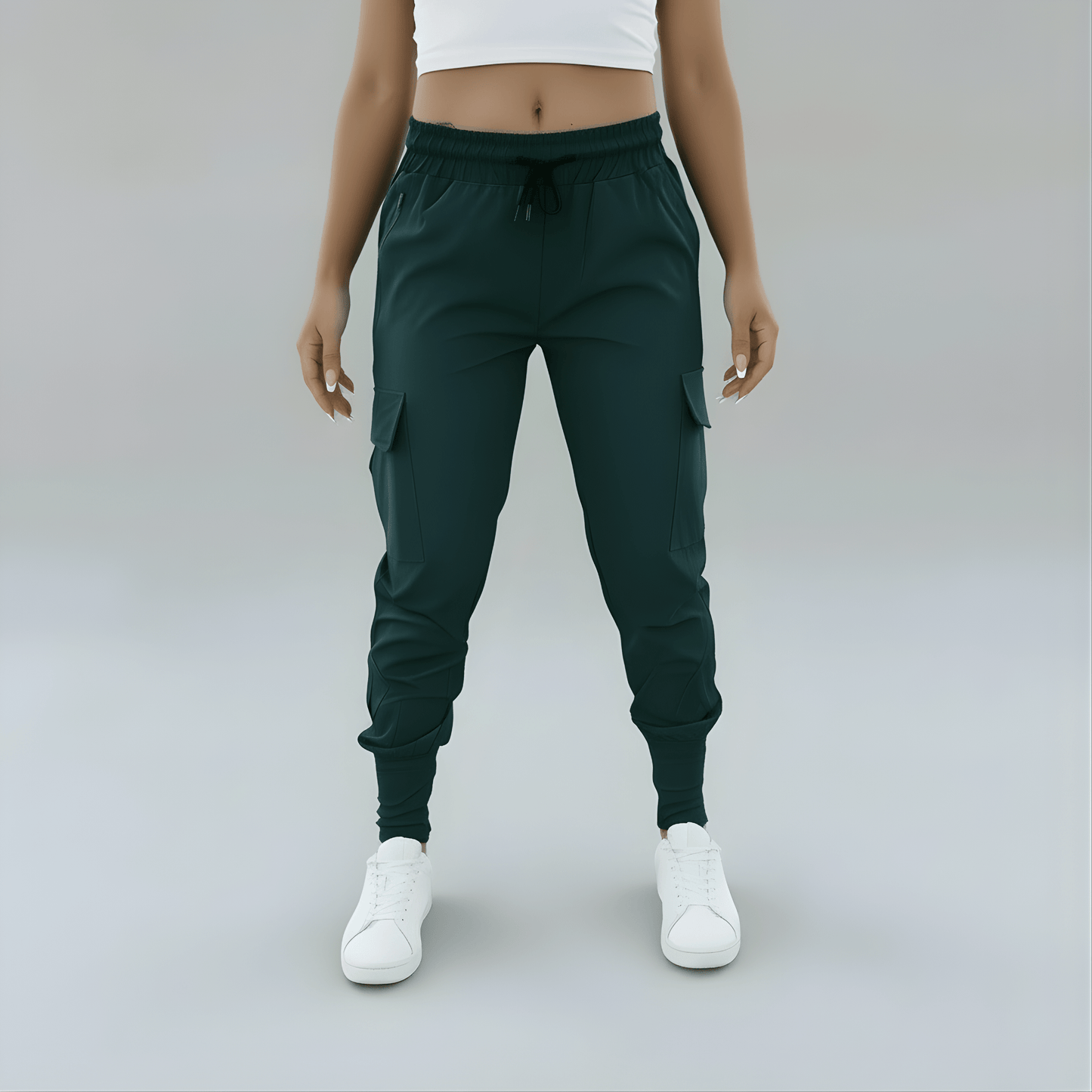 Person wearing dark green jogger pants and white sneakers on a plain background