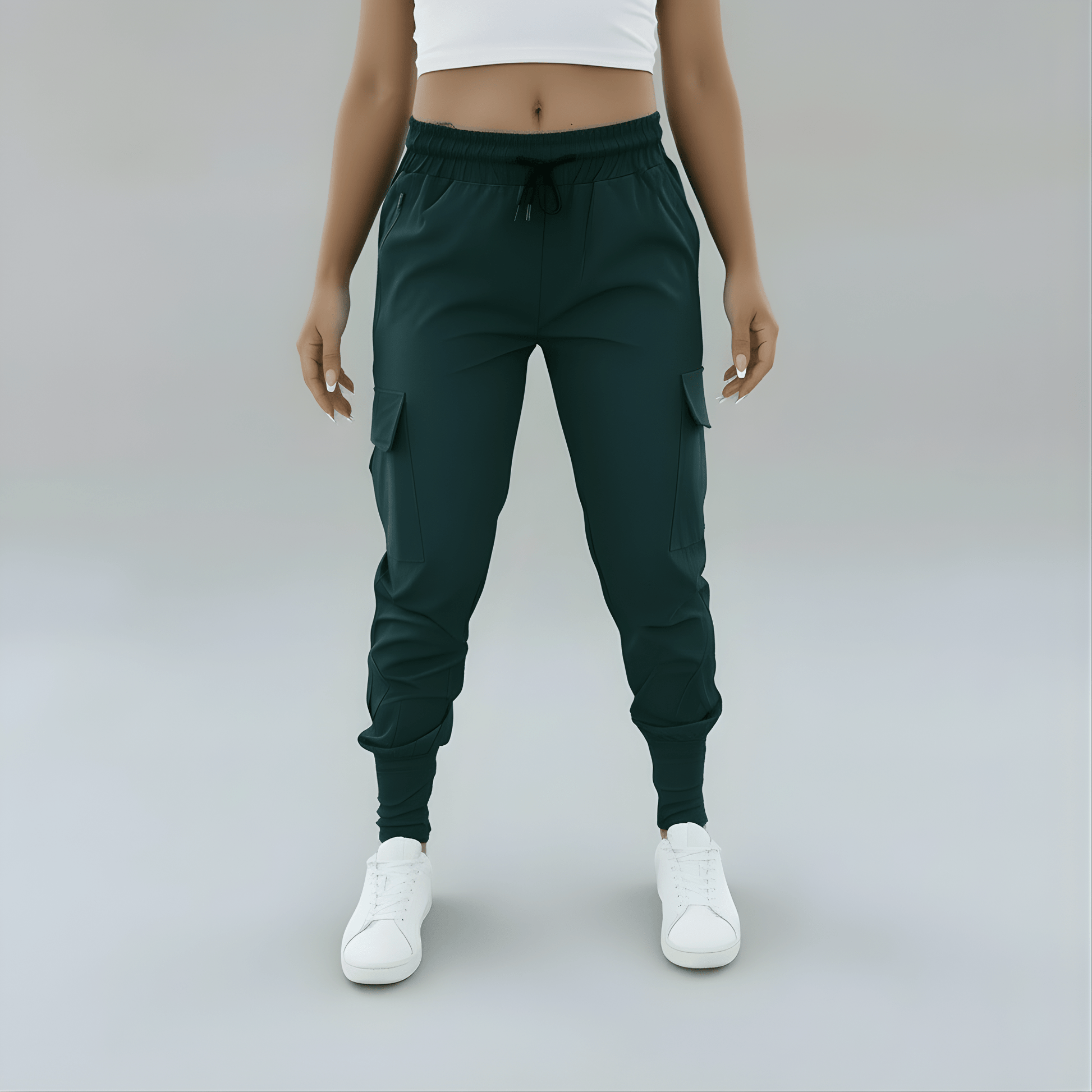 Person wearing dark green jogger pants and white sneakers on a plain background