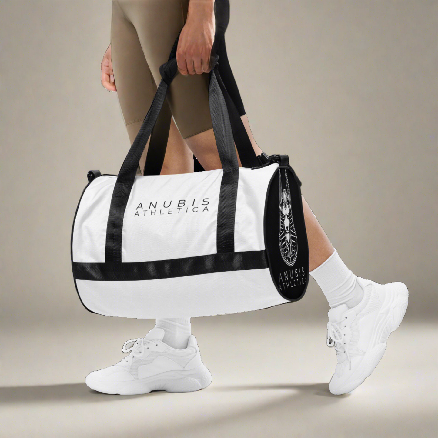 person walking and holding a Medium sized white gym bag