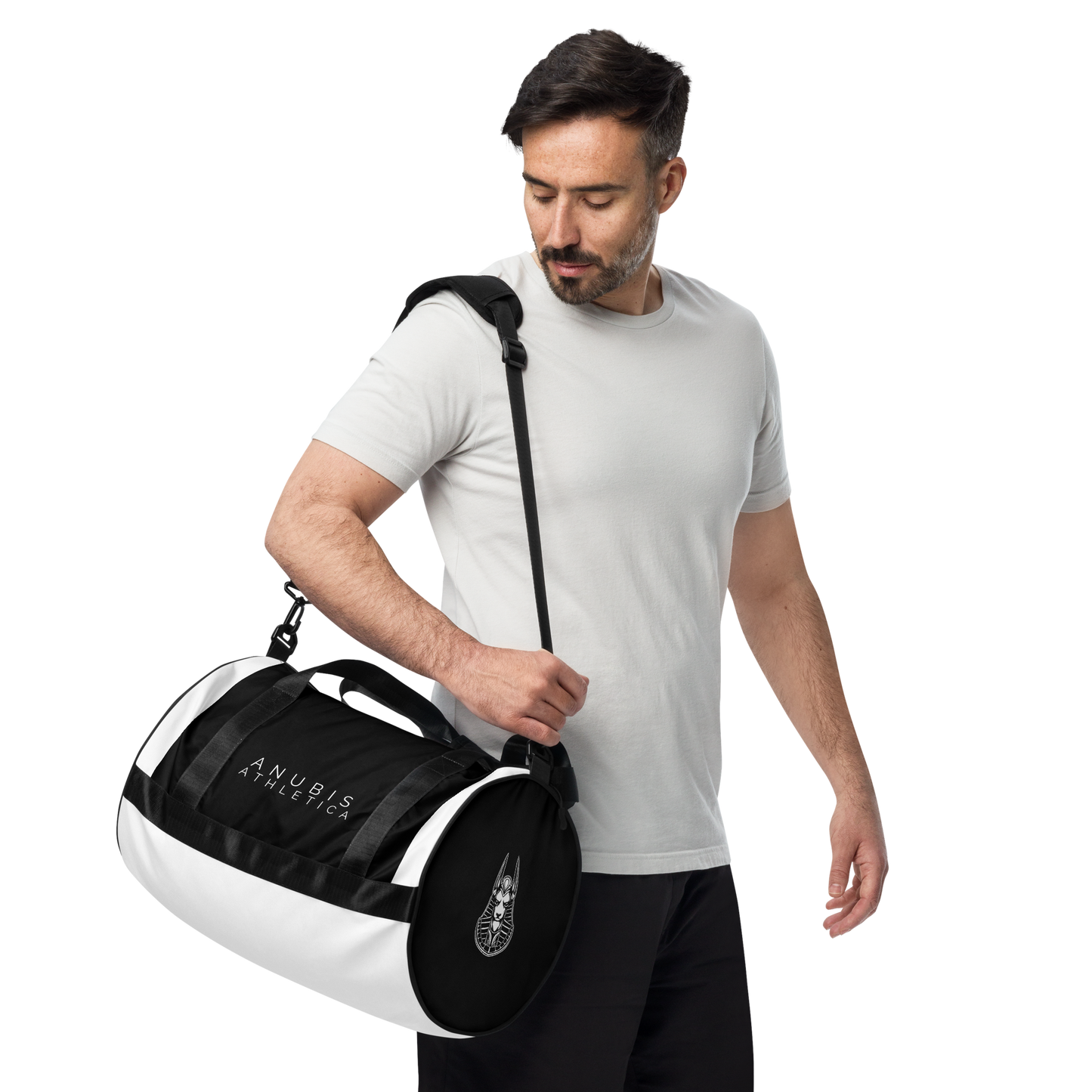 Man holding a Medium sized black and white gym bag