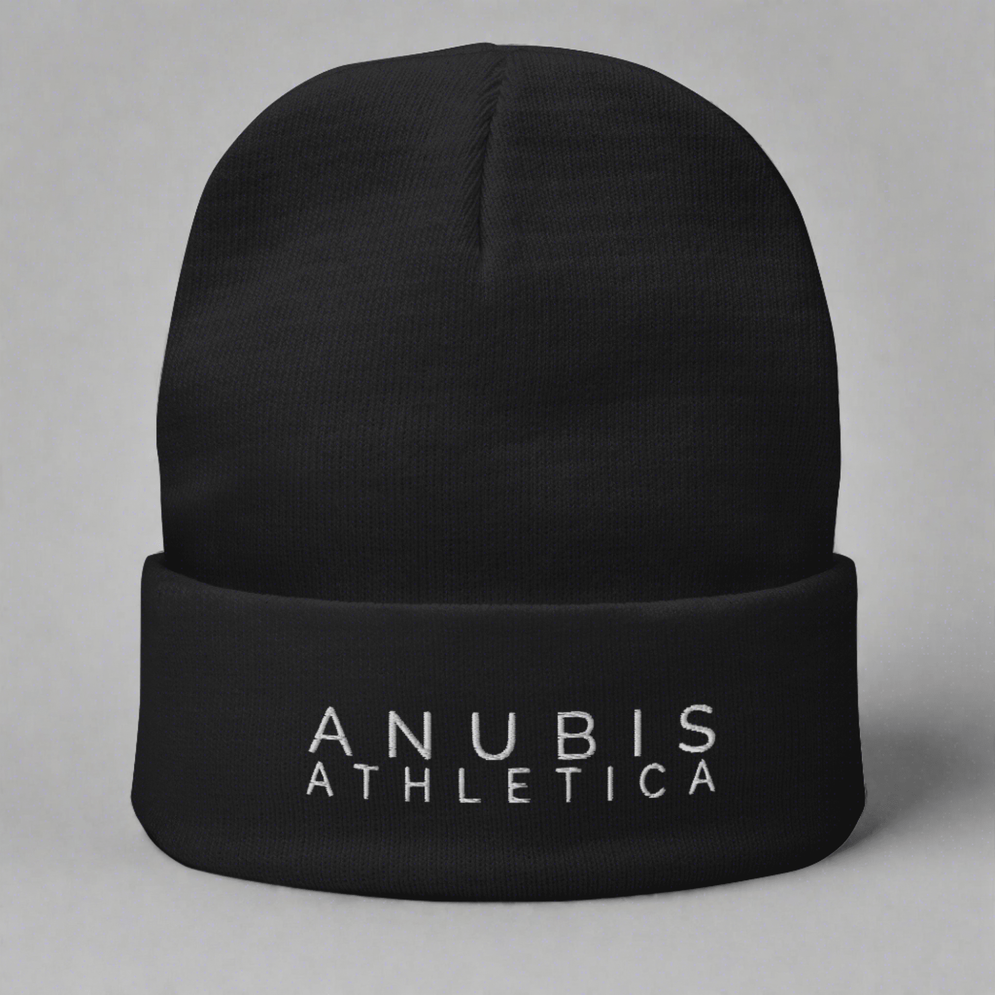 Knit beanie with the words Anubis Athletica embroidered on the front . Beanie color is black