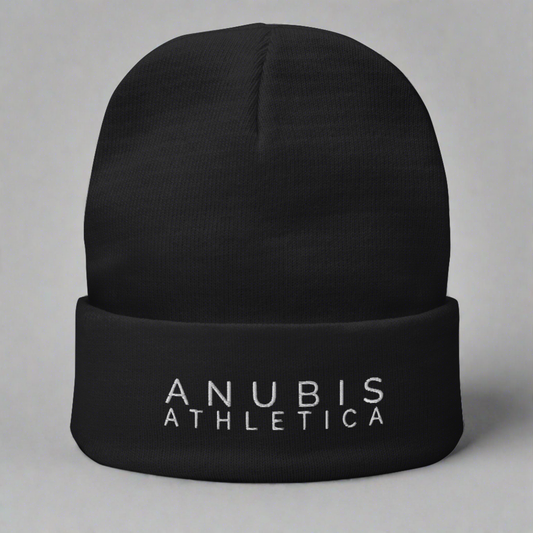 Knit beanie with the words Anubis Athletica embroidered on the front . Beanie color is black