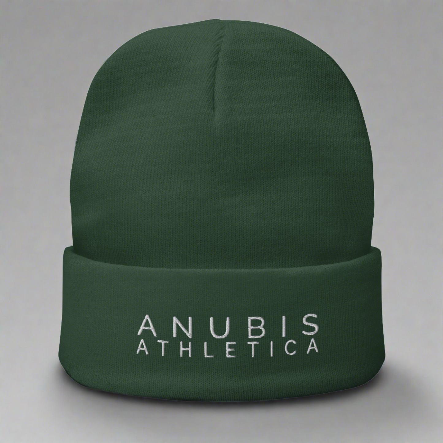 Knit beanie with the words Anubis Athletica embroidered on the front . Beanie color is green