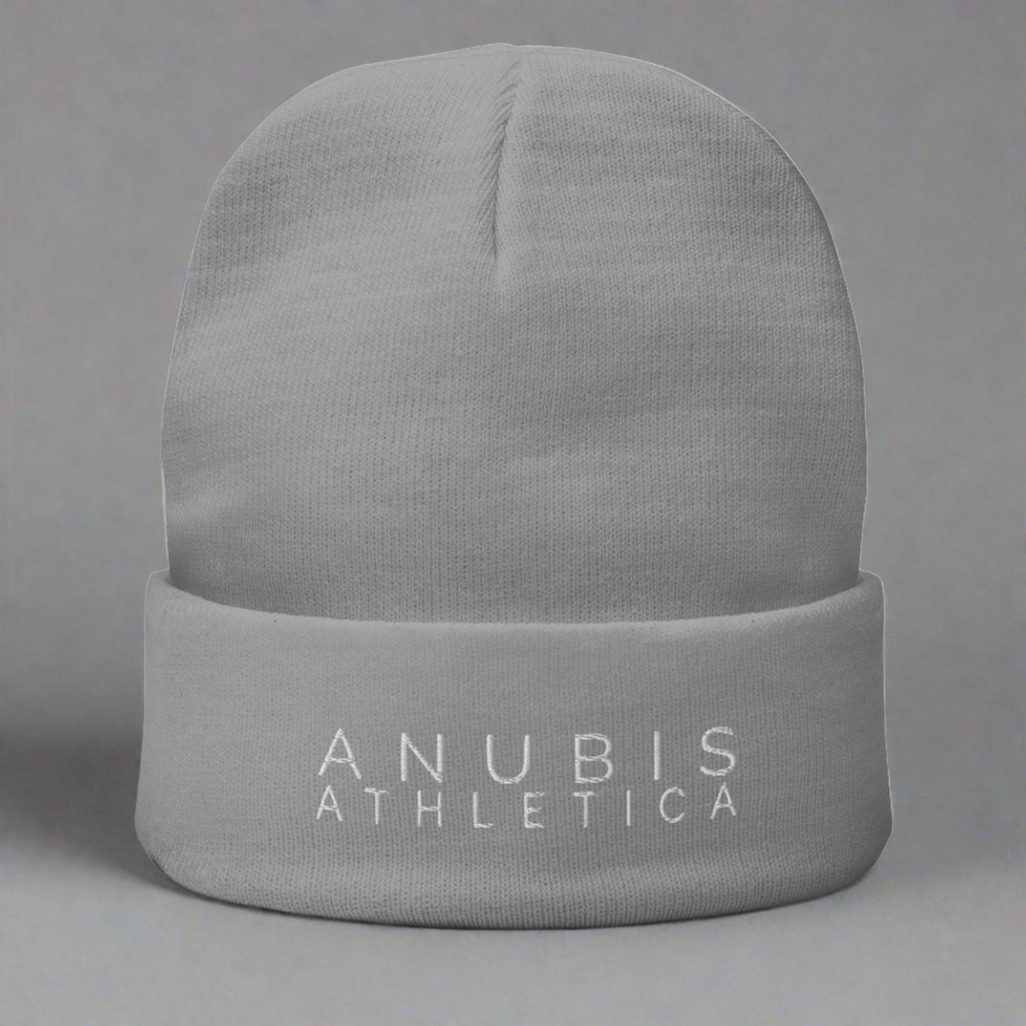 Knit beanie with the words Anubis Athletica embroidered on the front . Beanie color is gray