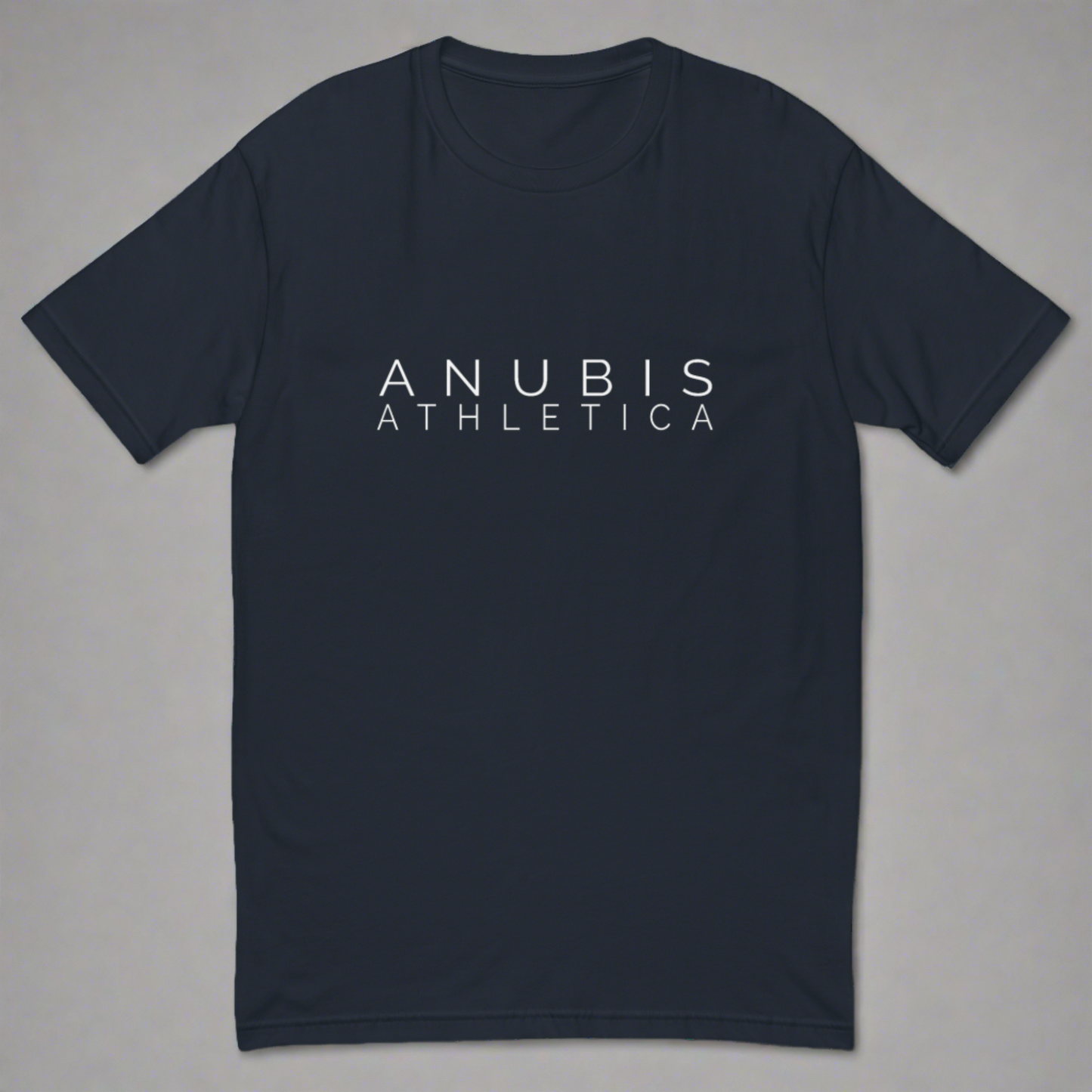 Fitted tee shirt in with the name Anubis Athletica on the front in white. Shirt is color midnight navy blue