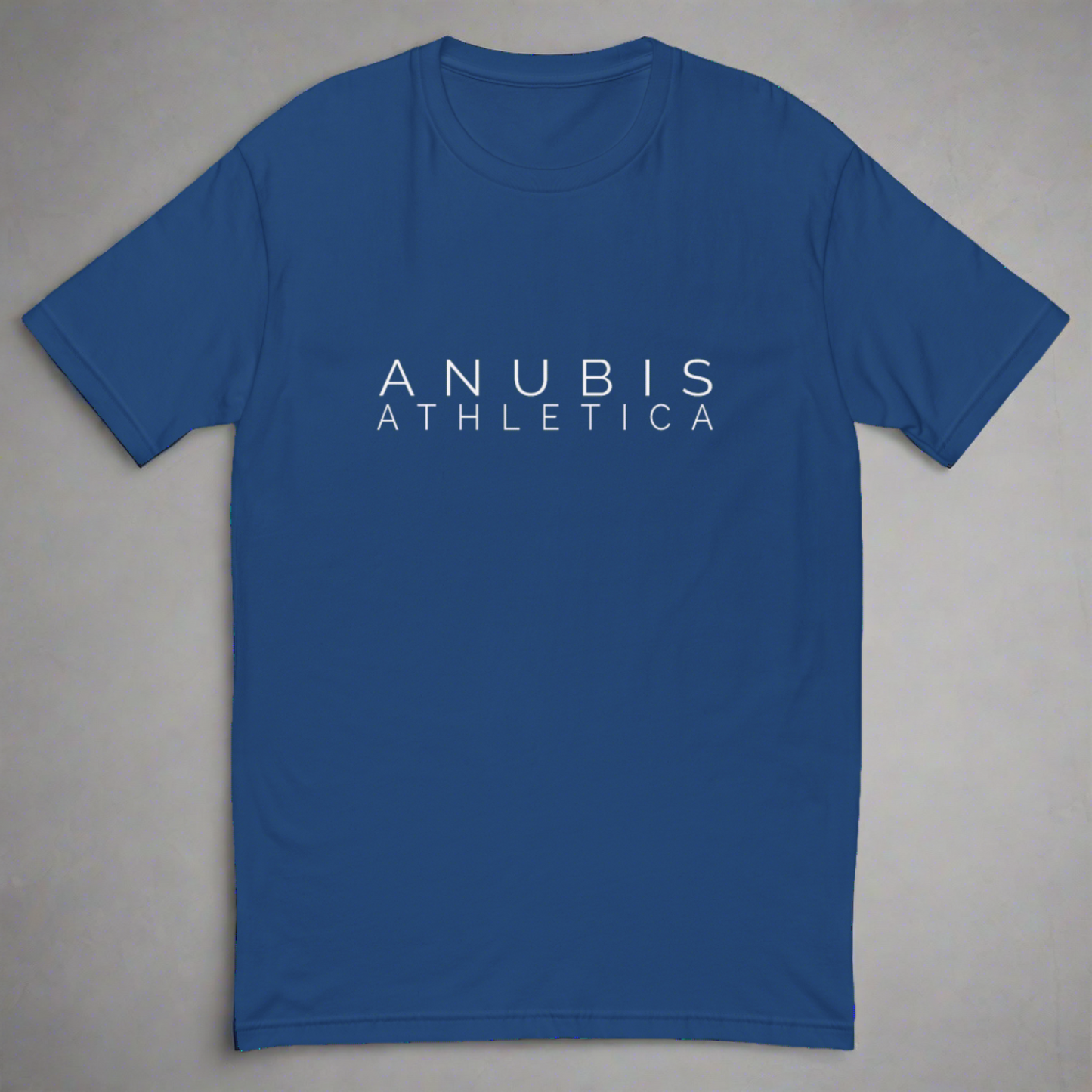 Fitted tee shirt in with the name Anubis Athletica on the front in white. Shirt is color royal blue