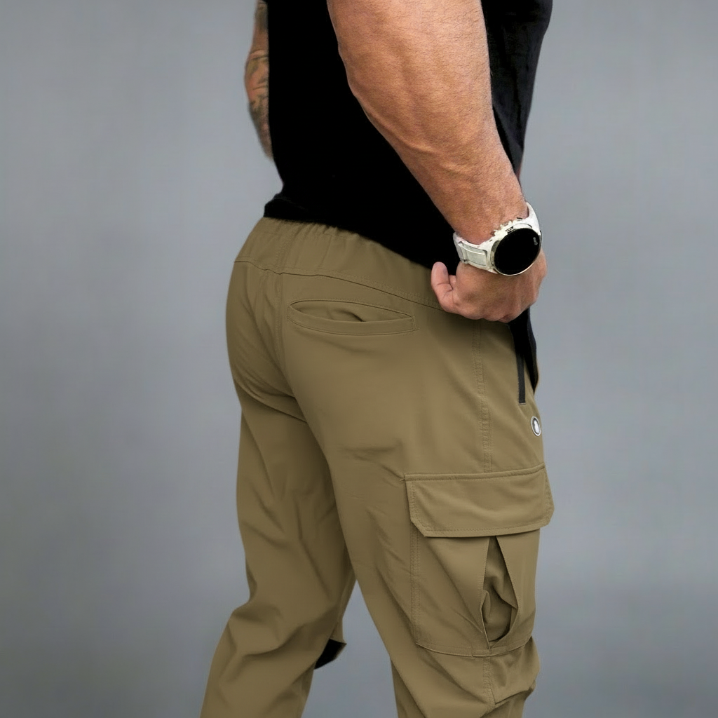 Person wearing beige cargo pants on a gray background