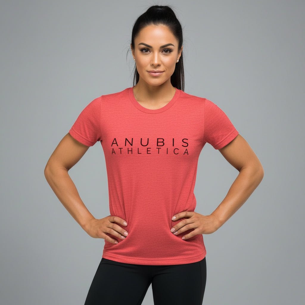 a brown haired women wearing a tee shirt with the name Anubis Athletica on the front printed in black. The shirt is the color red