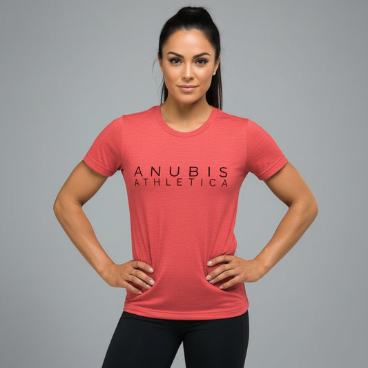 a brown haired women wearing a tee shirt with the name Anubis Athletica on the front printed in black. The shirt is the color red